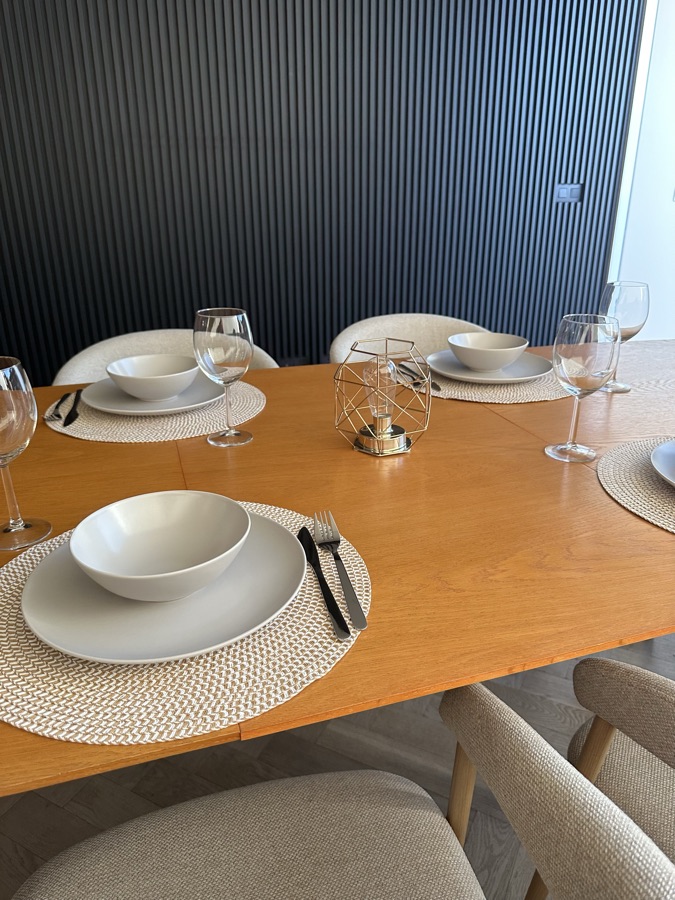 Gedekte eettafel met borden, kommen en wijnglazen